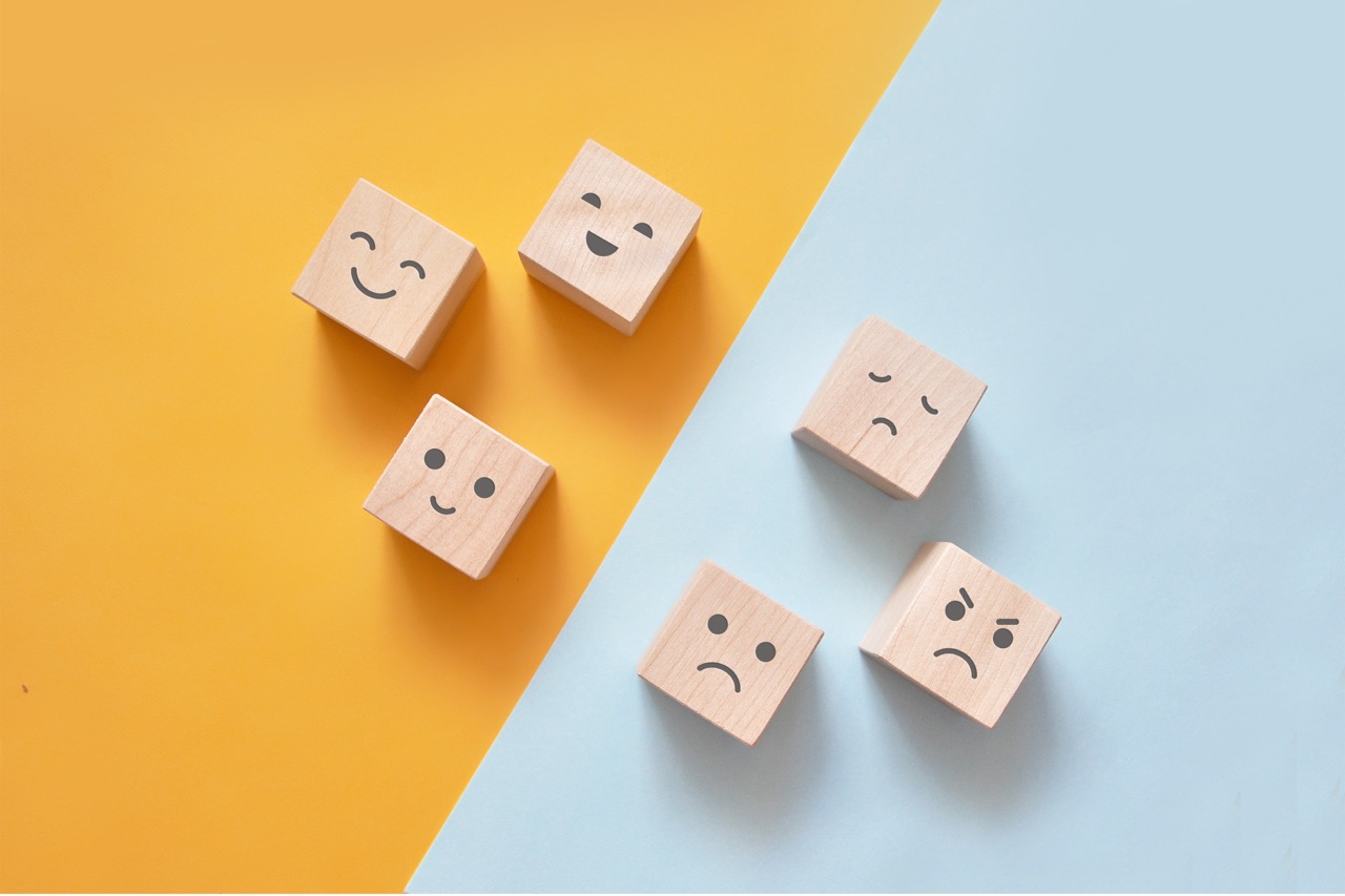 wooden blocks with various emotions on their faces